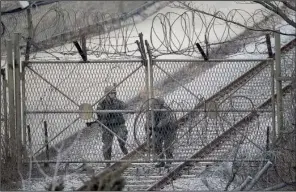  ?? AP/ AHN YOUNG- JOON ?? South Korean army soldiers close a gate Monday in Paju, near the border with North Korea.