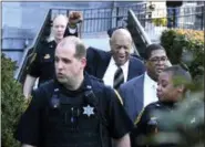  ?? MEL EVANS — THE ASSOCIATED PRESS ?? With a bystander cheering him on, Bill Cosby, center, raises his cane as he leaves hearings for jury selection in his sexual assault retrial, with spokespers­on Andrew Wyatt, wearing glasses, Thursday at the Montgomery County Courthouse in Norristown.