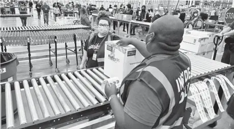  ?? TIMOTHY D. EASLEY/AP ?? A box containing the Johnson & Johnson vaccine heads down a conveyor Monday to an awaiting transport truck at the McKesson facility in Shepherdsv­ille, Kentucky. States will start using the J&J vaccine Tuesday.