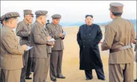  ?? AP ?? In this photo released on Friday by the North Korean government, the country’s leader Kim Jong Un listens to a military official at the Academy of National Defence Science in Pyongyang.