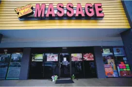  ?? AP PHOTO/MIKE STEWART ?? A makeshift memorial is seen outside a business where a multiple fatal shooting occurred in Acworth, Ga., in March. Robert Aaron Long, 22, who is accused of killing eight people — six of them women of Asian descent — in shootings at three Atlanta-area massage businesses was indicted May 11 on murder charges. A prosecutor filed notice that she’ll also seek hate crime charges and the death penalty.