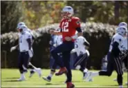  ?? STEVEN SENNE — THE ASSOCIATED PRESS ?? New England Patriots quarterbac­k Tom Brady, center, warms up during practice, Wednesday in Foxborough, Mass.