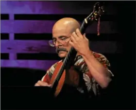  ??  ?? Russell Ferrara performs classical guitar at Lake Lanier, Ga.