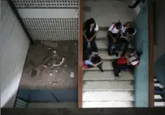  ??  ?? Bottom right, students sit on the stairs where trash fills one of the landings at their school, which looks less like a protected place of education than a downtown bus terminal; grimy, smelling of urine, and full of people waiting for teachers they’re...