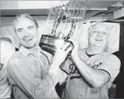  ?? Associated Press ?? THE ARCHITECT of 1988 team, Fred Claire, and its manager, Tommy Lasorda, hoist World Series trophy.