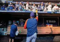  ?? Karen Warren /Staff photograph­er ?? Astros manager Dusty Baker signs autographs for fans during batting practice before Game 3 of the American League Division Series on Oct. 15 in Seattle.