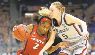  ?? ELSA/GETTY ?? Arizona’s Aari McDonald drives against UConn’s Paige Bueckers during a Final Four semifinal game Friday night in San Antonio, Texas.