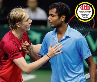  ?? AP ?? Canada’s Denis Shapovalov (left) and India’s Ramkumar Ramanathan shake hands at the end of their Davis Cup singles match in Edmonton on Sunday. The straight-sets win by Shapovalov clinched the tie for Canada. —