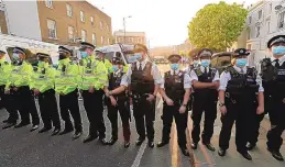  ?? MATT DUNHAM/ASSOCIATED PRESS ?? A police line stands outside Stamford Bridge stadium in London where Chelsea fans were protesting against Chelsea’s decision to be included among the clubs attempting to form a new European Super League.