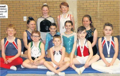  ??  ?? Children show off their medals