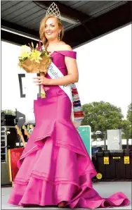  ?? Photo by Mike Eckels ?? Sara Garner of Fayettevil­le walks for the crowd after winning the 2016 Miss Decatur Barbecue title Aug. 6 at Veterans Park in Decatur. Garner beat out four other contestant­s to take the title.