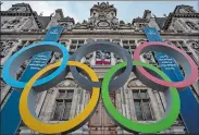  ?? AURELIEN MORISSARD/AP FILE PHOTO ?? Above, the Olympic rings are displayed in front of the Paris City Hall earlier this year. The IOC announced Friday that some Russian athletes will be allowed to compete at the 2024 Paris Olympics, a decision that removed the option of a blanket ban over the invasion of Ukraine.