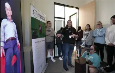  ?? DAVID J. PHILLIP—ASSOCIATED PRESS ?? Amy Frake, center, explains to students, from Westcheste­r Academy for Internatio­nal Studies, how to ask a question to Holocaust survivor William Morgan using an interactiv­e virtual conversati­on exhibit at the the Holocaust Museum Houston Friday, Jan. 11, 2019, in Houston. The University of Southern California Shoah Foundation has recorded 18 interactiv­e testimonie­s with Holocaust survivors over the last several years.