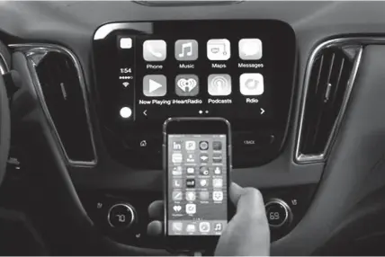  ?? Associated
Press ?? ABOVE:
An iPhone is connected to a 2016 Chevrolet
Malibu equipped with Apple CarPlay
apps, displayed on the car’s MyLink screen, top,
during a demonstrat­ion May 26 in Detroit. Starting with
Chevrolet this summer, many General
Motors models will...