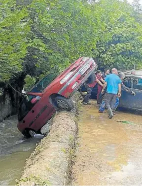  ?? ?? Vecinos retiran los coches al borde de la regata.