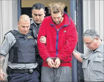  ?? ANDREW VAUGHAN/THE CANADIAN PRESS ?? Codey Reginald Hennigar is taken from court in Dartmouth in 2015.