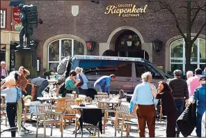  ?? AP/STEPHAN R. ?? People stand in front of a restaurant in Muenster, Germany, on Saturday after a vehicle crashed into a crowd.