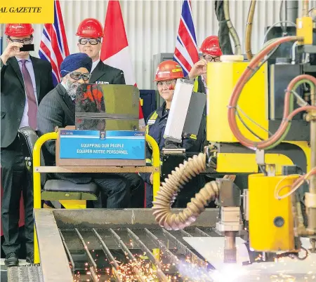  ?? SEASPAN ?? Defence Minister Harjit Sajjan cuts the first steel for the navy’s supply ships at Seaspan’s Vancouver Shipyards in June. The new ships are being constructe­d of U.S. steel even as President Donald Trump’s tariffs punish Canadian producers of the same product with 25-per-cent tariffs.
