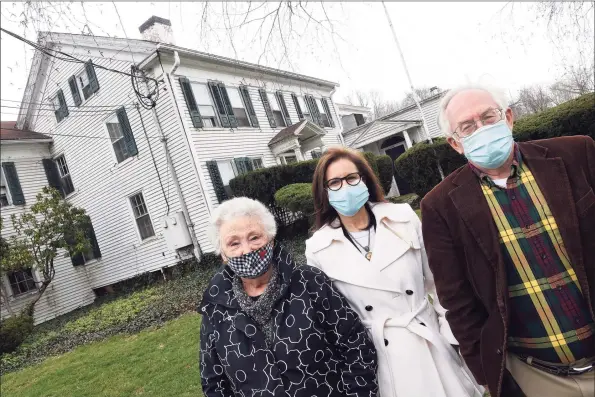  ?? Arnold Gold / Hearst Connecticu­t Media ?? From left, Guilford Preservati­on Alliance pPresident Shirley Girioni, Gayle Slossberg, vice president and chief compliance officer for Yale New Haven Health, and town historian Joel Helander are photograph­ed in front of the historic Sachem Country House in Guilford on Thursday.