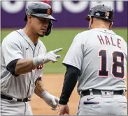  ?? PHIL LONG — THE ASSOCIATED PRESS ?? Detroit Tigers’ Wilson Ramos, left, is congratula­ted by third base coach Chip Hale, right, after hitting a solo home run during Sunday’s road loss to the Cleveland Indians.