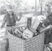  ??  ?? The Caridad Center handed out thousands of toys to more than 600 families Saturday morning as part of its 10th annual Meet Santa gift event. Santa attended the event, sitting under a tent and welcoming toddlers and small children to his lap. The center...