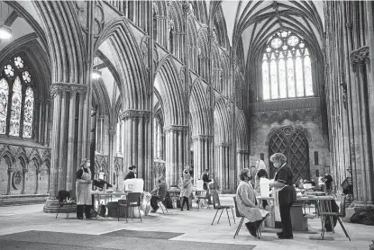  ?? Oli Scarff / AFP via Getty Images ?? The Astrazenec­a vaccine is given to the public at the Lichfield cathedral, which has been converted into a temporary vaccinatio­n center, in Lichfield, England. Astrazenec­a is expected to apply in the coming weeks for U.S. authorizat­ion for its vaccine.