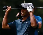  ?? ASSOCIATED PRESS ?? TIGER WOODS REACTS TO HIS second shot on the eighth hole during the first round of the PGA Championsh­ip golf tournament Thursday at Bellerive Country Club in St. Louis.