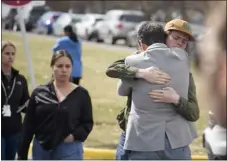  ?? DAVID ZALUBOWSKI — THE ASSOCIATED PRESS ?? A student, right, hugs a parent as they are reunited following a shooting at East High School, Wednesday, March 22, 2023, in Denver.