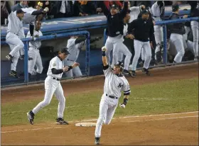  ?? BILL KOSTROUN — THE ASSOCIATED PRESS ?? Yankees’ Derek Jeter celebrates his game-winning home run in the 10th inning as he rounds first base in Game 4of the World Series against the Diamondbac­ks at Yankee Stadium in New York on Oct. 21, 2001.