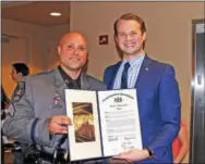  ?? CHRIS BARBER – DIGITAL FIRST MEDIA ?? State Rep. Eric Roe, R-158, right, presents a Pennsylvan­ia House of Representa­tives citation to Joseph Greenwait for his life-saving actions. Missing from the picture is Jeremy O’Neill, who also received a citation for life saving.