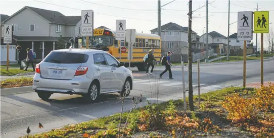  ?? [WHITNEY NEILSON / THE OBSERVER] ?? The design of this crosswalk on Church Street which sees plenty of school children crossing to get to and from Riverside Public School is being questioned by Woolwich Coun. Mark Bauman. He’s concerned drivers aren’t aware of new pedestrian rules...