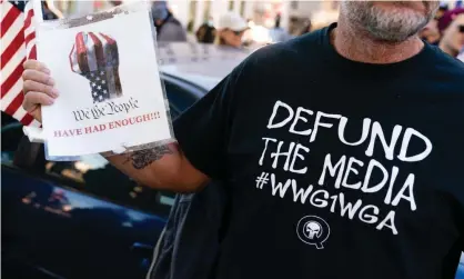  ?? Photograph: Elijah Nouvelage/Getty Images ?? A Trump supporter wears a QAnon shirt at a ‘Stop the steal’ protest in Atlanta.