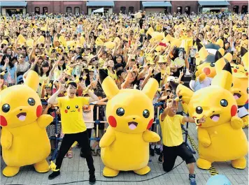  ??  ?? All smiles and cartoon monsters for a Pokémon live event in Yokohama, Japan, above. Left: Pokémon Go ‘genius’ John Hanke