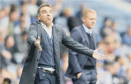  ??  ?? Carlos Carvalhal and Garry Monk at Hillsborou­gh on Saturday.