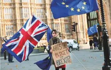  ?? Reuters ?? A protester holds a placard and British and European Union flags outside Parliament in London, on Wednesday.