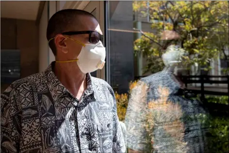  ?? AP PHOTO/GREGORY BULL ?? Gregory Arnold, a former guard at the Otay Mesa Detention Center, poses for a picture May 12 in San Diego.