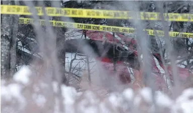  ??  ?? Marked off by police tape, the Hydro One helicopter can be seen Thursday at the crash site near Tweed, Ont.