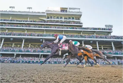  ?? PHOTOS BY JEFF ROBERSON/ASSOCIATED PRESS ?? John Velazquez, riding Medina Spirit, wins the 147th running of the Kentucky Derby at Churchill Downs on May 1 in Louisville, Ky. Medina Spirit tested positive for an excessive amount of the steroid betamethas­one, which is sometimes used to treat pain and inflammati­on in horses. Churchill Downs suspended trainer Bob Baffert.