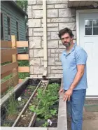  ?? BEHM / MILWAUKEE JOURNAL SENTINEL ?? Aaron Pierce diverted his home’s roof downspout into a StormGUARD­en.