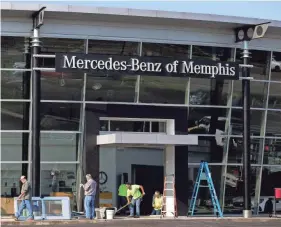  ?? MAX GERSH / THE COMMERCIAL APPEAL ?? Crews work Wednesday to clean up and install new doors at Mercedes-benz of Memphis. Four vehicles were stolen from the dealership overnight, two of which were driven through the front door windows of the showroom, according to police reports.