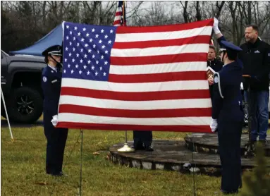  ?? COURTESY OF NPHS JROTC ?? North Penn High School’s Air Force Junior ROTC cadets hold an American flag at a “Wreaths Across America” event honoring fallen veterans in Hilltown in December.