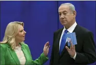  ?? MAYA ALLERUZZO - THE ASSOCIATED PRESS ?? Likud party chairman Benjamin Netanyahu and his wife Sara vote at a polling station in Jerusalem on Tuesday. The race was too close to call.