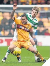  ??  ?? Scott McDonald holds off Celtic’s Stuart Armstrong.