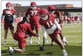  ?? (NWA Democrat-Gazette/David Gottschalk) ?? Arkansas defensive lineman Mataio Soli (11) participat­es in an agility drill during Thursday’s practice in Fayettevil­le. Soli, who has 12 career starts, is one of five returning players with solid starting experience for the Razorbacks. More photos at arkansason­line.com/42practice/.