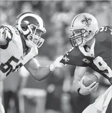  ?? Sean M. Haffey Getty Images ?? SAMSON EBUKAM gets his second career sack by latching on to Drew Brees in last week’s win over the New Orleans Saints. On Sunday the Rams rookie will make his first start in place of the injured Connor Barwin.