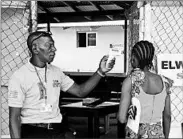 ?? ABBAS DULLEH/AP ?? A family member of a 15-year-old boy who has Ebola has her temperatur­e measured by a health worker in Monrovia.