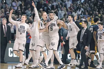  ?? Mary Schwalm Associated Press ?? VILLANOVA PLAYERS CELEBRATE after defeating West Virginia in the East Regional semifinal at Boston, sparked by 13-of-24 shooting on three-pointers. The top-seeded Wildcats will face Texas Tech on Sunday with a trip to the Final Four on the line. D5