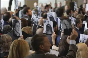  ?? (AP/Evan Vucci) ?? Audience members hold up photos showing people killed in the Holocaust, during the U.S. Holocaust Memorial Museum’s Annual Days of Remembranc­e ceremony at the U.S. Capitol on Tuesday in Washington.