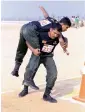  ?? APP ?? A Sri Lankan army soldier is rescuing his colleague during the physical agility competitio­n being held in Lahore. —