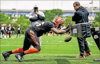  ?? NICK GRAHAM / STAFF ?? Defensive end Carlos Dunlap (hitting a sled during the Bengals’ team activities in May) earned his first Pro Bowl berth last season as he totaled 13.5 sacks, a modern-era franchise record.